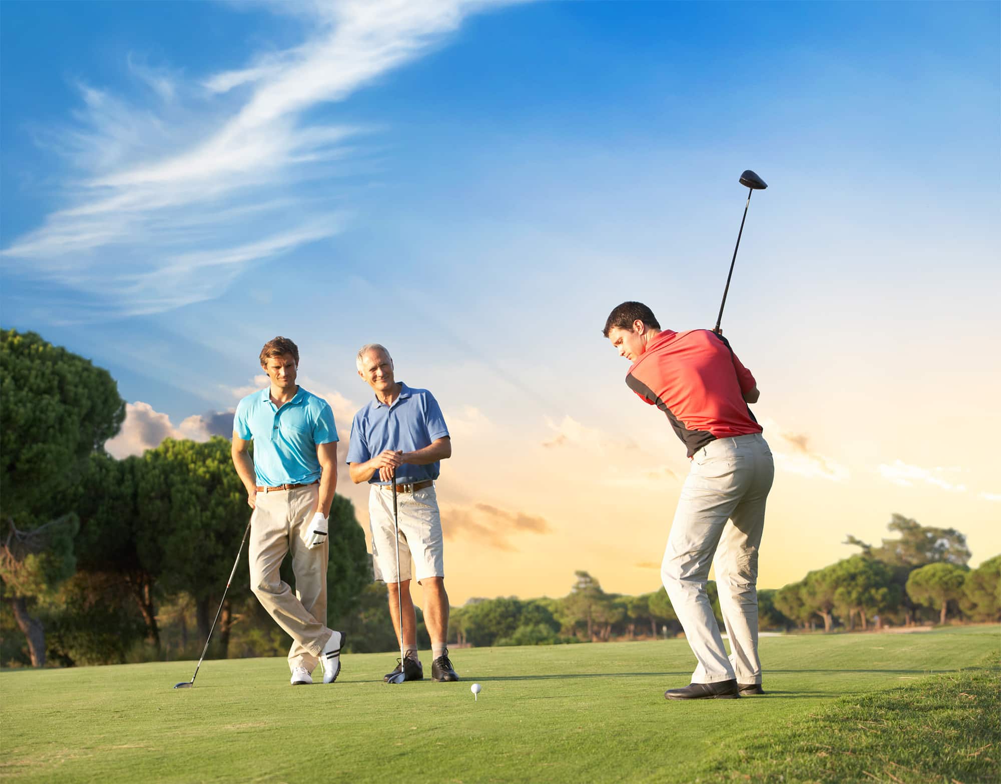 Three men golfing